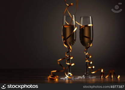 Glasses of champagne at new year party. Two champagne glasses ready to bring in the New Year