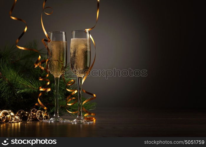 Glasses of champagne at new year party. Two champagne glasses ready to bring in the New Year