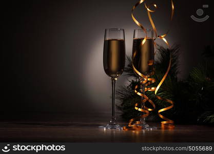 Glasses of champagne at new year party. Two champagne glasses ready to bring in the New Year