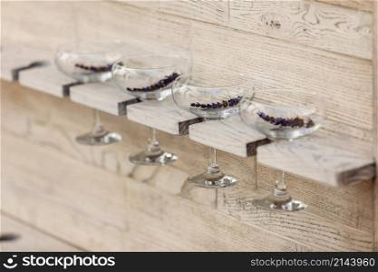 Glasses of champagne decorated with lavender on wooden background.. Glasses of champagne decorated with lavender on wooden background
