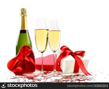 Glasses of champagne with bottle and gifts
