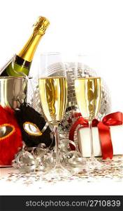 Glasses of champagne with mask and gift