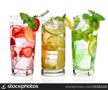 Glasses Of Drink With Ice Cubes And Fruits On White Background