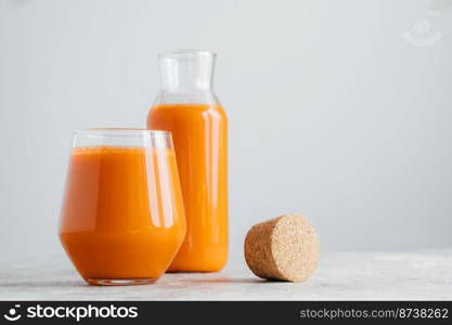 Glasses of fresh pressed carrot juice on white background. Homemade beverage for your healthy drink. Delicious drink full of vitamin C.