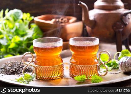 glasses of hot tea with teapot