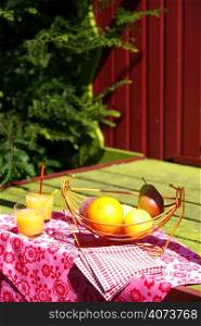 Glasses of orange juice and fruit on a table