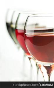 glasses of pink , red and white wine , close up shot