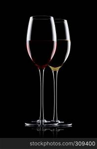 Glasses of red and white wine on black background with reflection