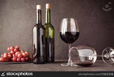 Glasses of red wine with bunch of grapes