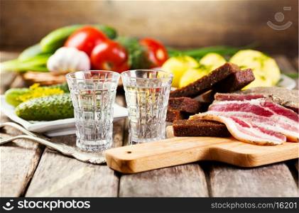 glasses of vodka with various traditional snack