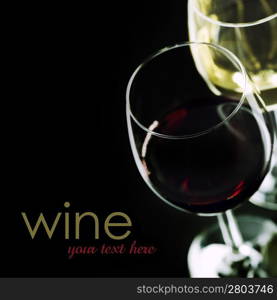 Glasses of wine on black background (easy removable sample text)