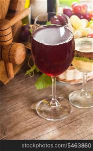 Glasses of wine on the old wooden background over oak barrel