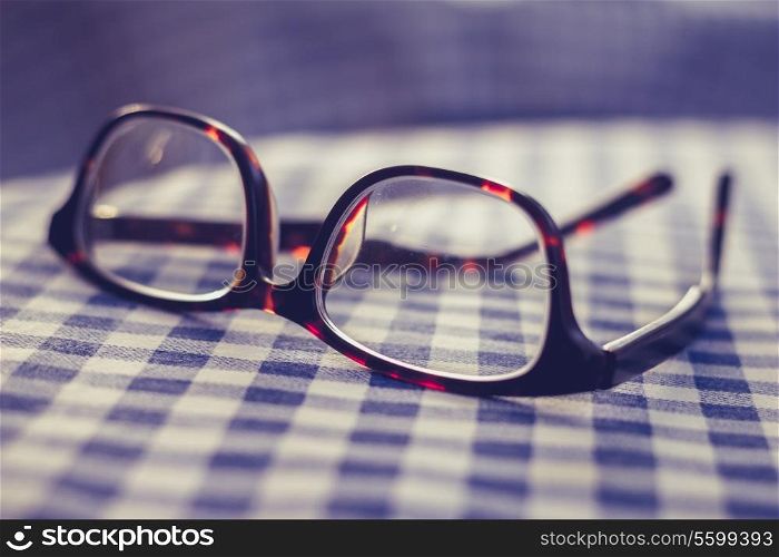 Glasses on checkered cloth