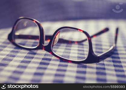 Glasses on checkered cloth