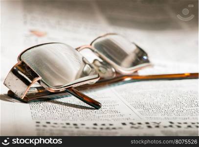 Glasses on newspaper. Natural lightings