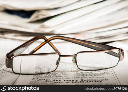 Glasses on newspaper. Natural lightings