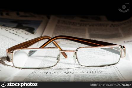 Glasses on newspaper. Natural lightings