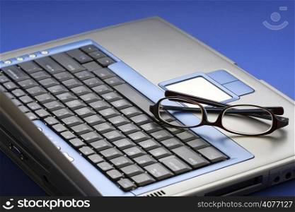 Glasses on top of a laptop