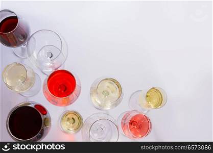 Glasses with red, white and rose wine, top view scene with copy space. Set of glasses with wine