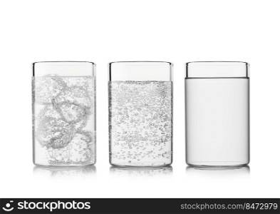 Glasses with sparkling and still mineral water with ice cubes on white.