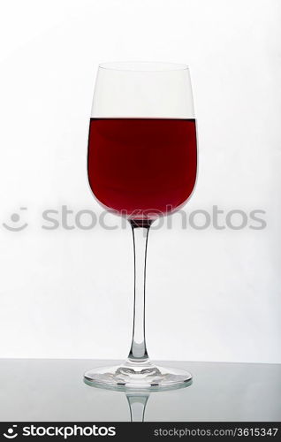 Glasses with wine on the color background