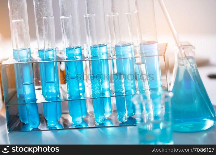 Glassware and blue liquid equipment in chemical laboratories