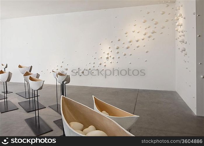 Glazed ceramics boats in art gallery