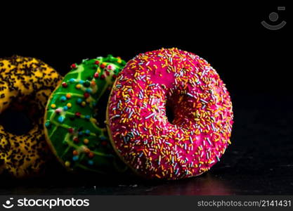 Glazed donuts with sprinkles isolated. Close up of colorful donuts.. Glazed donuts with sprinkles isolated. Close up of colorful donuts.