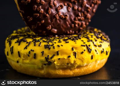 Glazed donuts with sprinkles isolated. Close up of colorful donuts.. Glazed donuts with sprinkles isolated. Close up of colorful donuts.