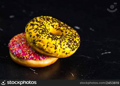 Glazed donuts with sprinkles isolated. Close up of colorful donuts.. Glazed donuts with sprinkles isolated. Close up of colorful donuts.