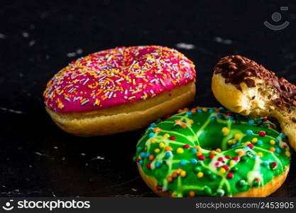 Glazed donuts with sprinkles isolated. Close up of colorful donuts.. Glazed donuts with sprinkles isolated. Close up of colorful donuts.