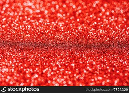Glitter and glow. Shiny festive red background. Abstract texture