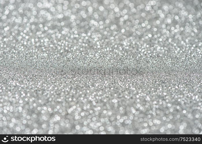 Glitter and glow. Shiny festive silver background. Abstract texture