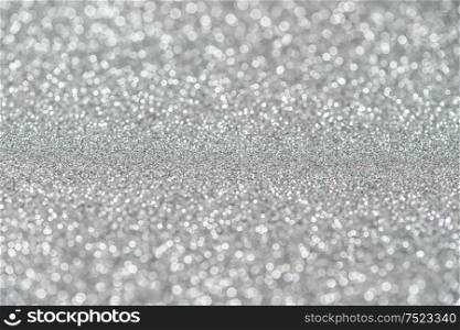 Glitter and glow. Shiny festive silver background. Abstract texture