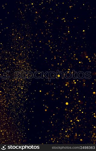 Glitter background shiny dust falling on dark backdrop