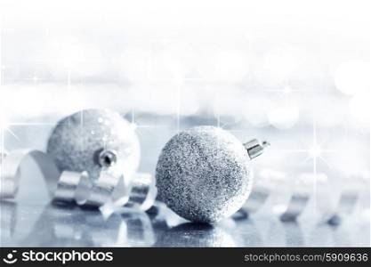Glitter christmas balls and ribbon close-up on bokeh background