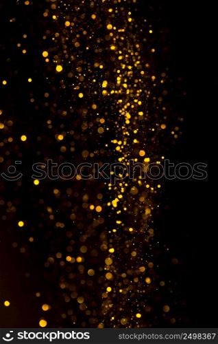 Glitter dust gold particles dark abstract background