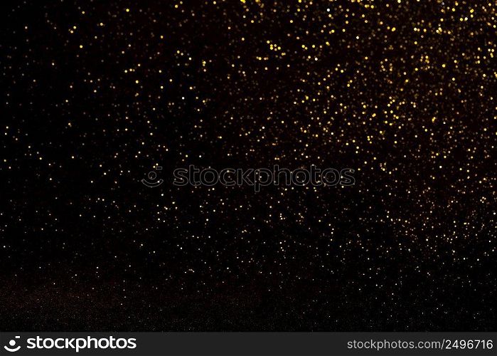 Glitter lights defocused abstract bokeh background. Shiny gold glitter festive stars bokeh. 