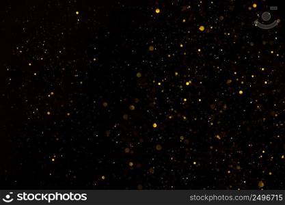 Glitter particles shiny star dust fall on black background