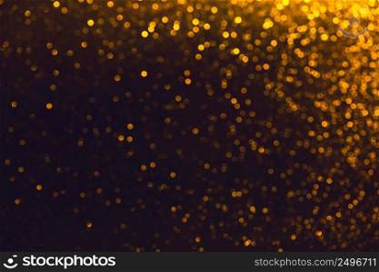 Glitter shiny defocused sparkles on black background