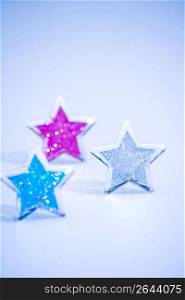Glitterey coloured silver stars isolated on a white background