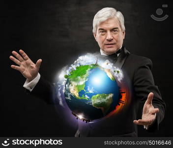 Global Business - A businessman holding world