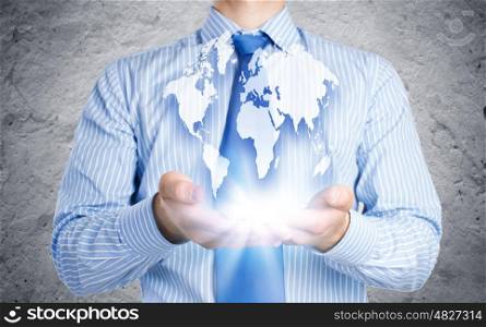 Global business. Close up of businessman holding Earth planet in palms