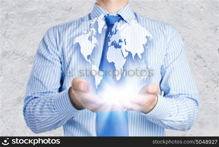 Global business. Close up of businessman holding Earth planet in palms