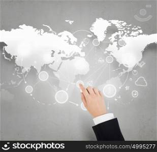 Global business interaction. Businessman hand touching icon on world map concept