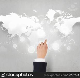 Global business interaction. Businessman hand touching icon on world map concept