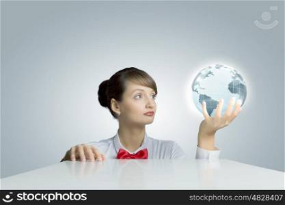 Global business. Young woman holding digital Earth planet in hand