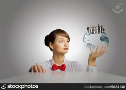 Global business. Young woman holding digital Earth planet in hand