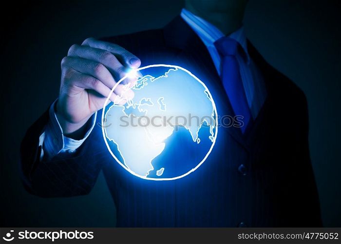 Global connection concept. Chest view of businessman drawing digital planet on screen