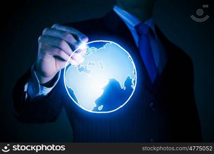 Global connection concept. Chest view of businessman drawing digital planet on screen